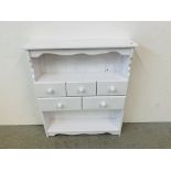 A WHITE PAINTED PINE FIVE DRAWER SHELF UNIT