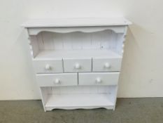 A WHITE PAINTED PINE FIVE DRAWER SHELF UNIT