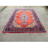 A GOOD QUALITY RED / BLUE PATTERNED EASTERN CARPET 3.3M X 3.15M.