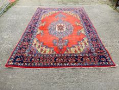 A GOOD QUALITY RED / BLUE PATTERNED EASTERN CARPET 3.3M X 3.15M.