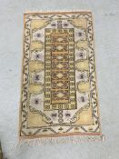 A TRTADITIONAL ORANGE/PURPLE PATTERNED RUG 80 X 140CM.