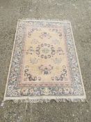 A CHINESE RUG BLUE / PINK PATTERNED ON BEIGE GROUND 1.7M X 1.25M.