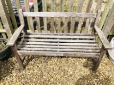 A WEATHERED HARDWOOD GARDEN BENCH LENGTH 130CM.