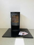 A MODERN TERMATECH CONTEMPORARY WOODBURNING STOVE WITH LOG STORE BELOW MOUNTED ON SHEET OF BLACK
