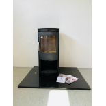 A MODERN TERMATECH CONTEMPORARY WOODBURNING STOVE WITH LOG STORE BELOW MOUNTED ON SHEET OF BLACK