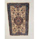 AN EASTERN RUG THE CENTRAL CIRCULAR MEDALLION ON AN IVORY FIELD BLUE / PINK DECORATION 147CM X 90CM.
