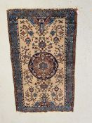 AN EASTERN RUG THE CENTRAL CIRCULAR MEDALLION ON AN IVORY FIELD BLUE / PINK DECORATION 147CM X 90CM.