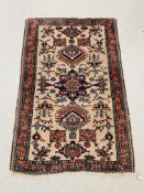 AN EASTERN RUG PINK / BLUE PATTERN ON AN IVORY FIELD 146CM X 95CM.