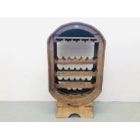 A LARGE OAK 21 BOTTLE CAPACITY WINE RACK WITH GLASS HOLDER AND SINGLE SHELF TO THE TOP.