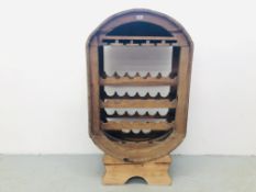 A LARGE OAK 21 BOTTLE CAPACITY WINE RACK WITH GLASS HOLDER AND SINGLE SHELF TO THE TOP.