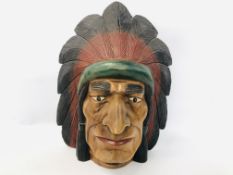 A NATIVE INDIAN HAND CARVED WALL MASK (HEIGHT 43CM.