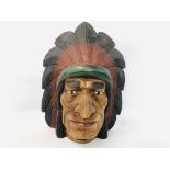 A NATIVE INDIAN HAND CARVED WALL MASK (HEIGHT 43CM.