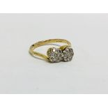 18CT GOLD (RUBBED MARKS) DIAMOND CROSS OVER STYLE RING SET WITH TWO FLOWER HEAD SETTING EACH HAVING