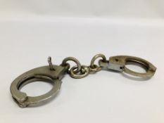 PAIR OF VINTAGE BRITISH MADE HANDCUFFS "HIATTS 1960" - WE CANNOT GUARANTEE THE ORIGINALITY OF THESE