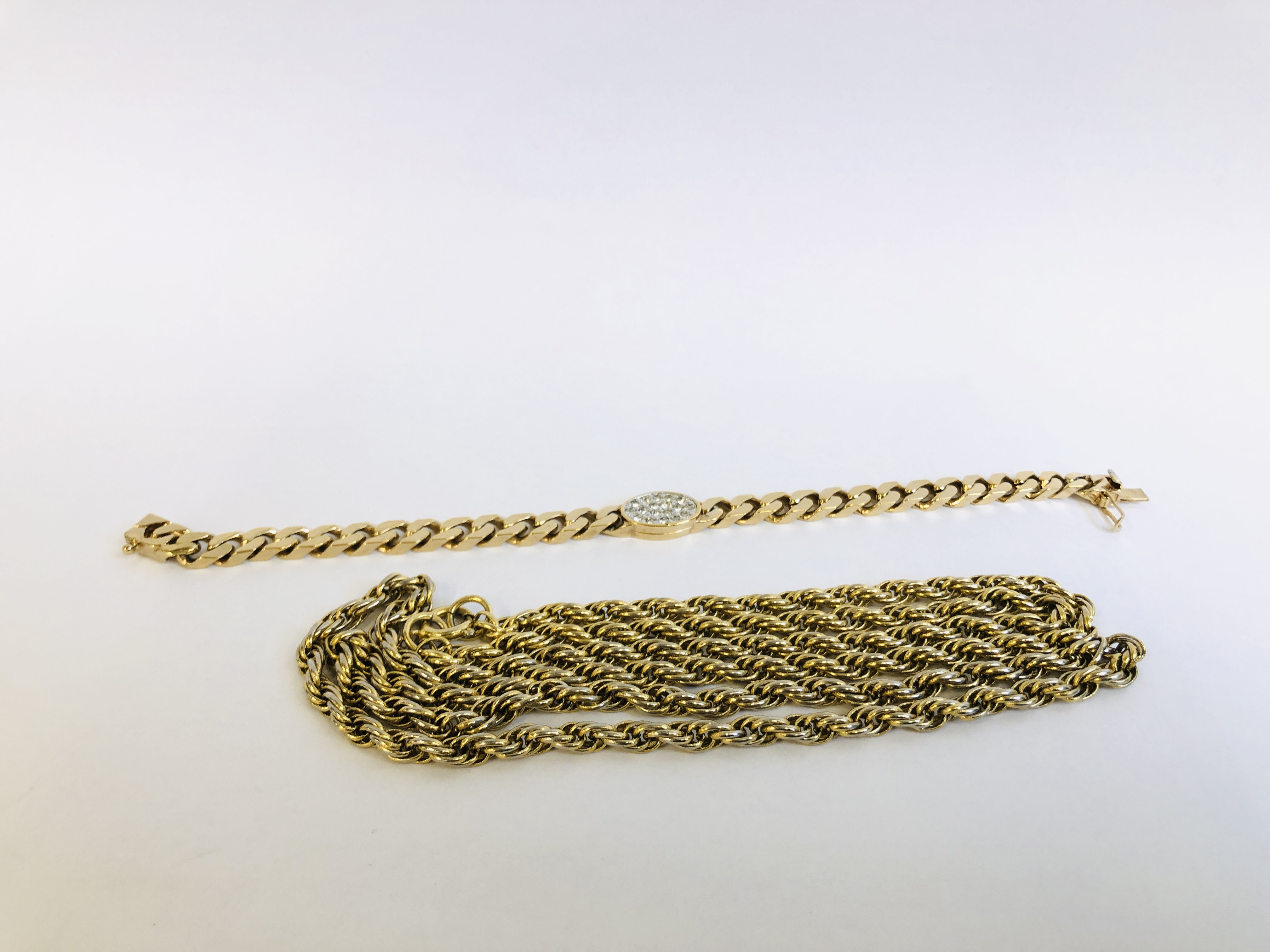 A GOLD TONE COSTUME BRACELET MARKED "PANETTA" ALONG WITH AN UNMARKED ROPE TWIST NECKLACE.