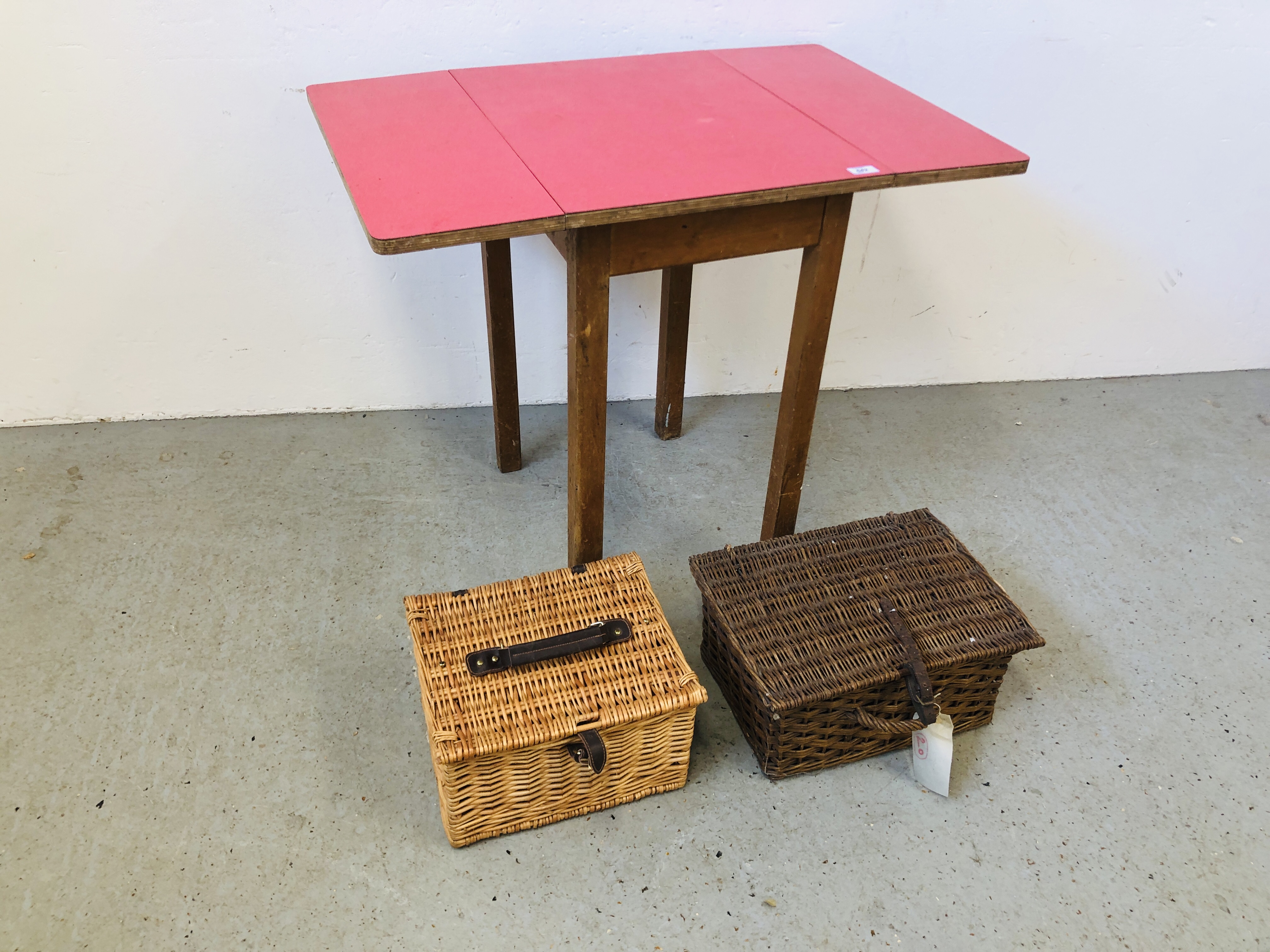 FORMICA DROP LEAF TABLE ALONG WITH TWO WICKER PICNIC BASKETS.