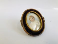 VINTAGE OVAL HANDPAINTED PORTRAIT MINATURE OF A YOUNG GIRL AND HOLDING FLOWERS.