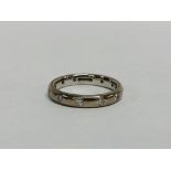 18CT WHITE GOLD WEDDING BAND SET WITH 11 SMALL DIAMONDS (1 MISSING).