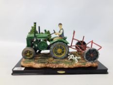 A JULIANA COLLECTION MODEL OF A TRACTOR CULTIVATING WITH DOG