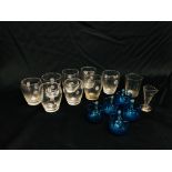 SEVEN GLASS BARREL SHAPED TUMBLERS WITH FLOWER HEAD HANDLES HEIGHT 6.5CM.