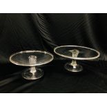 TWO GEORGIAN CIRCULAR GLASS TAZZA'S, THE FLUTED COLUMN ON A BASE WITH FOLDED FOOT, D 28CM AND 35.