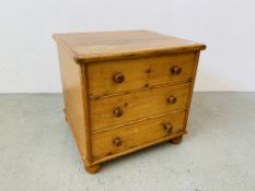 A WAXED PINE HINGED TOP COMMODE WITH THREE FAKE DRAWERS WIDTH 52CM. DEPTH 48CM. HEIGHT 51CM.