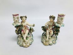 A PAIR OF DERBY FIGURAL CANDLESTICKS, THE SEATED BOY AND GIRL HOLDING A BASKET OF FLOWERS, H 17.
