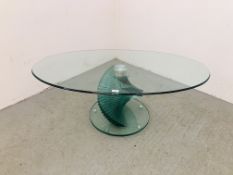 A MODERN DESIGNER GLASS COFFEE TABLE OF OVAL FORM.