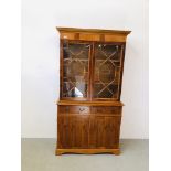 A REPRODUCTION YEW WOOD FINISH ASTRAGAL GLAZED BOOKCASE STANDING ON TWO DRAWER CABINET BASE W 105CM,