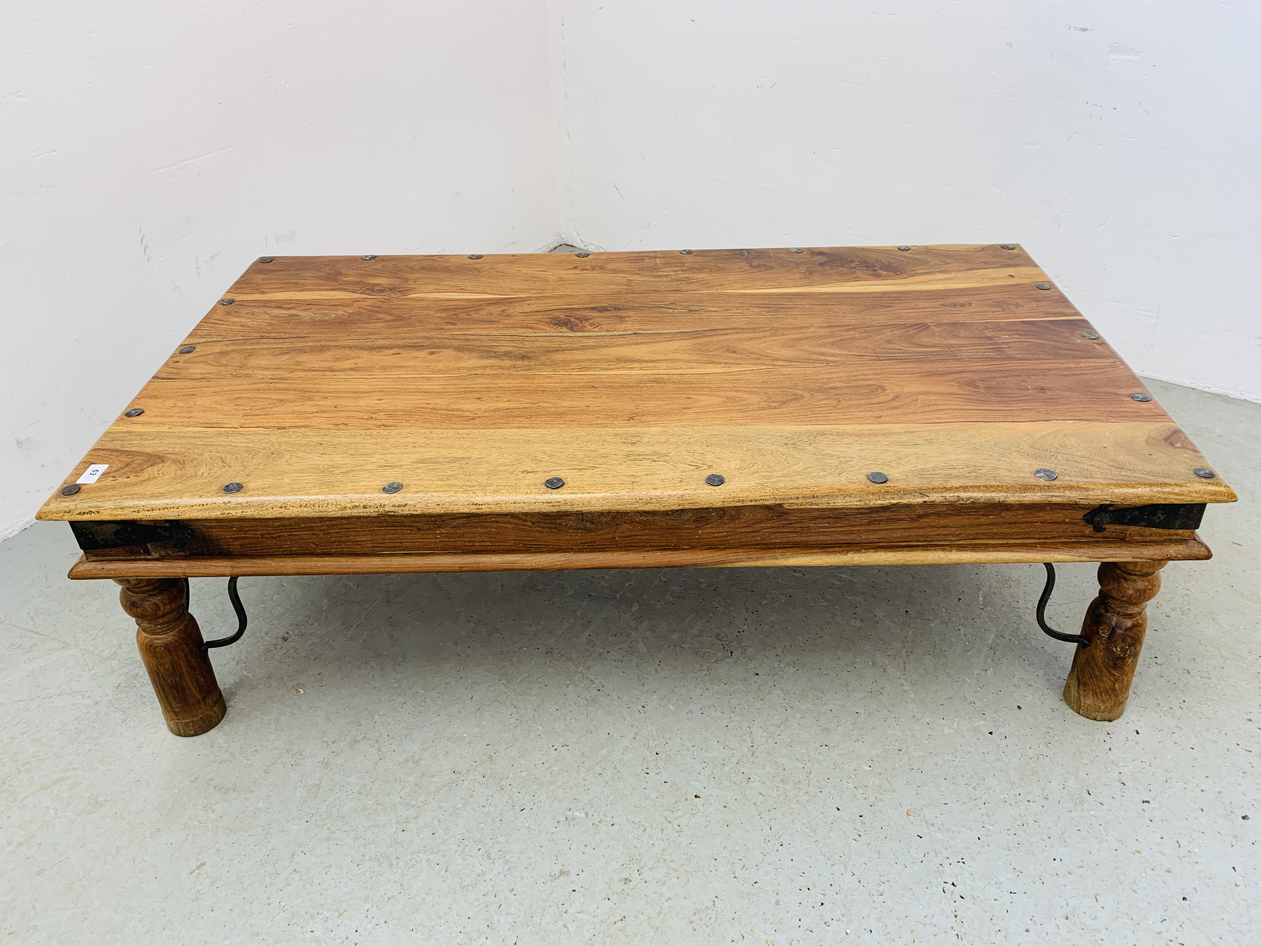 RUSTIC HARDWOOD COFFEE TABLE, STUD AND METAL WORK DETAIL LENGTH 135CM. WIDTH 75CM. HEIGHT 40CM.