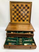 A ORNATE CHESS BOARD ALONG WITH FIGURES FITTED IN BESPOKE TWO DRAWER BOX W 61CM, H 23CM, D 40CM.