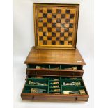 A ORNATE CHESS BOARD ALONG WITH FIGURES FITTED IN BESPOKE TWO DRAWER BOX W 61CM, H 23CM, D 40CM.