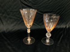 TWO FACETED GLASSES, THE BOWL TINTED PINK, THE STEM WITH HOBNAIL CUT KNOP, 17CM.