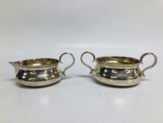 A SILVER CREAM AND SUGAR BOWL OF MATCHING DESIGN