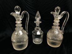 PAIR OF EARLY C19TH WINE JUGS THE LOOP HANDLES ON A CUT GLASS BODY BOTH WITH CRACKS IN RING NECK