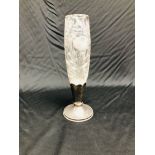 A C20th TAPERED CYLINDRICAL CUT GLASS VASE, HAVING FLORAL DECORATION, ON A SILVER PLATED BASE, 31CM.