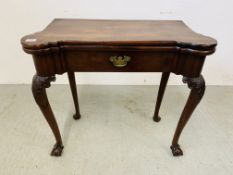 A GEORGE III MAHOGANY SINGLE-DRAWER FOLDING GAMES TABLE THE BAIZED TOP WITH CANDLE CORNERS AND