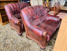 A PAIR OF OXBLOOD LEATHER TWO SEATER SOFAS.