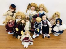 2 BOXES OF DRESSED PORCELAIN DOLLS.