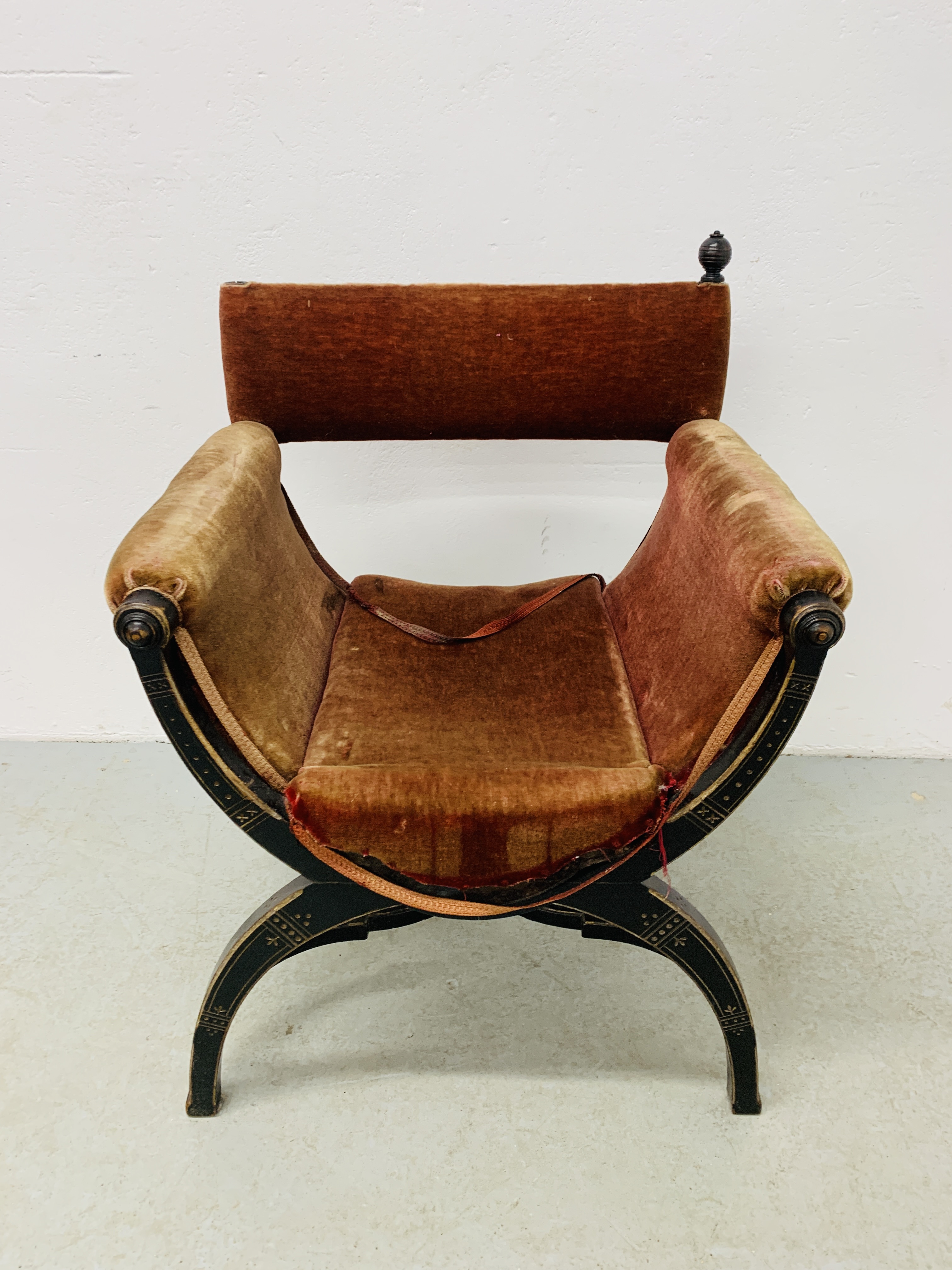 A C19TH EBONISED 'X' FRAME ARMCHAIR,