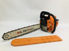 A MIL GERMANY PETROL CHAIN SAW FITTED WITH 18 INCH BAR CHAIN AND COVER.