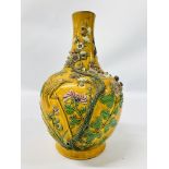 A MAJOLICA BOTTLE VASE, YELLOW GROUND WITH RAISED DECORATION INCLUDING BIRDS AND PRUNUS BLOSSOM.