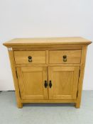 MODERN LIGHT OAK FINISH TWO DRAWER TWO DOOR SIDEBOARD ALONG WITH A BEECH FINISH MAGAZINE RACK.