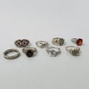 EIGHT SILVER AND STONE SET RINGS