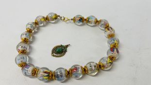 ORIENTAL GLASS BEADED NECKLACE INSET WITH FIGURES ALONG WITH AN ORIENTAL GILT AND ENAMELLED PENDANT.