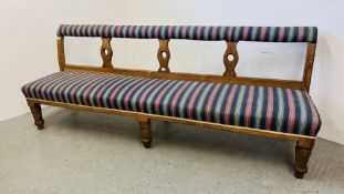 AN ANTIQUE UPHOLSTERED BENCH SEAT BEARING "TREVOR PAGE & CO. NORWICH" LABEL LENGTH 2.5M.