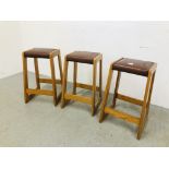 THREE PINE FRAMED BREAKFAST BAR STOOLS WITH BROWN LEATHER PADDED SEAT HEIGHT 62CM.