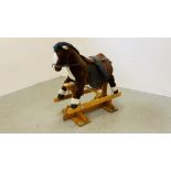 A MODERN CHILDS ROCKING HORSE WITH LEATHER SADLE