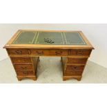 A REPRODUCTION YEW WOOD FINISH TWIN PEDESTAL DESK, THE TOP WITH GREEN TOOLED LEATHERETTE W 122CM,