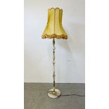 ORNATE BRASS AND ONYX STANDARD LAMP WITH GOLD FRINGED SHADE - SOLD AS SEEN.